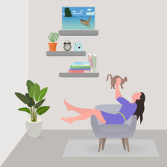 Woman sitting on sofa at living room and playing with cat. She held  cat with both hands. On holiday weekend.