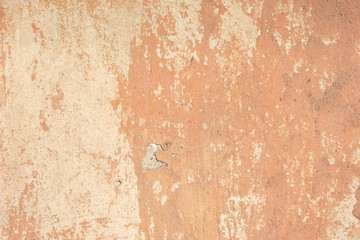 beige cracked plaster texture, with elements of rubbed white paint. Pastel tone textured street wall