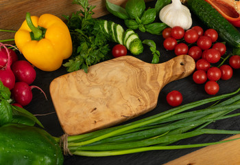Sliced Cucumber with Green Vegetables on Rustic Cutting Board