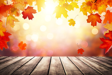 Naklejka na ściany i meble Wooden table top on blur autumn background