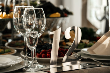 Crystal glasses on the wedding table for guests with number 12