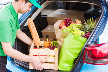 Asian delivery man grocery prepare service giving fresh vegetables food and fruit full in wooden...