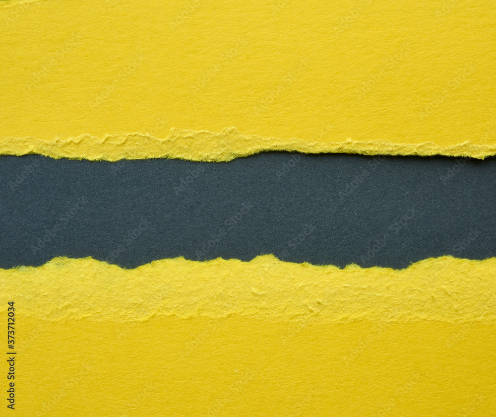 Poster background of layered yellow torn paper with a shadow on a black background