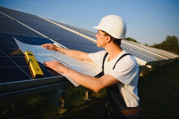 Worker installing solar panels outdoors