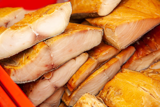 Sale of smoked Kamchatka fish. Far Eastern seafood, natural smoked fish - inconnu salmon at the city Christmas market