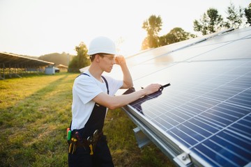 Young adult doing professional training on solar panels plant