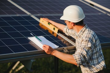 Worker installing solar panels outdoors