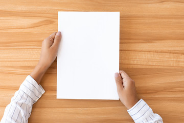 Woman hand holding blank paper sheet A4 size