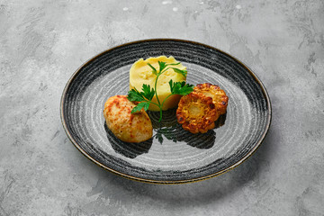 Ground meat cutlet with mashed potato and grilled corn