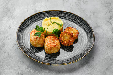 Ground meat cutlet with mashed potato and grilled corn