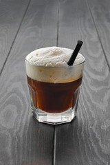 Glass of espresso with vegetable whipped cream foam