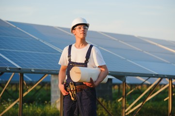Worker installing solar panels outdoors