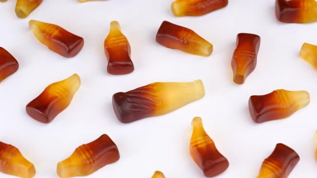 Candy sweets background. Assorted colorful gummy candies. Colorful delicious cola bottle jelly sweets turning.
