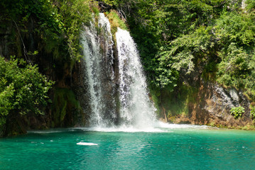 Waterfall and turquoise lake