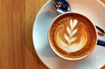 Top view latte art, Hot coffee decoration art in white cup with copy space.