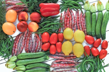 geometric composition of fruits and vegetables on white table top view