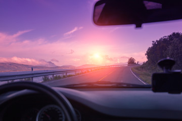 The highway along fjord at sunset. View from the windscreen. Beautiful nature of Norway