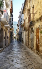 Fototapeta na wymiar narrow street in the old town of Fondi, in Latina province, Italyl