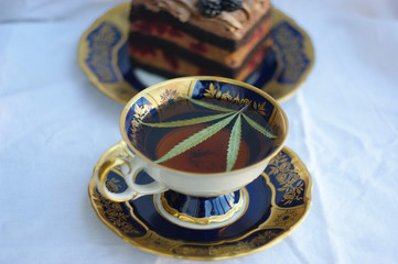 cannabis (hemp) tea. classic leaf of cannabis (marijuana) in a glass of tea