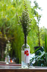 
Flowers in bottles in a street cafe