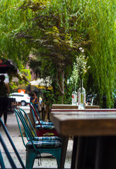 
Flowers in bottles in a street cafe