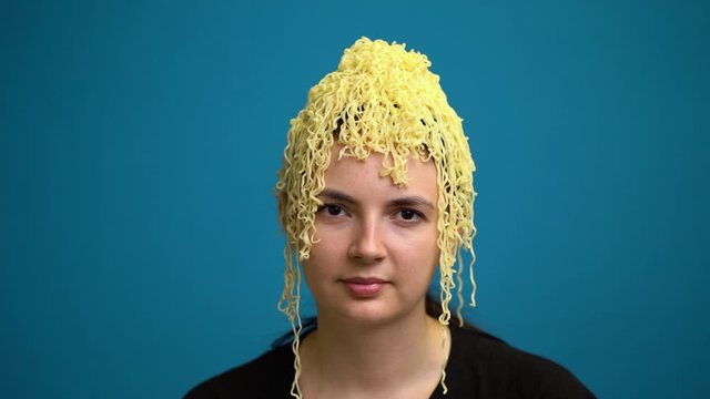 Portrait woman with pasta on the head.