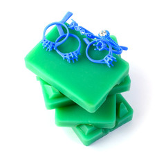 Molded rubber, wax, blue rings and white diamonds stacked vertically on a white background.