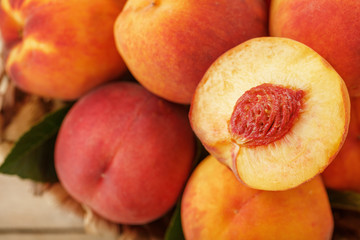 A slice of juicy and ripe peach with a close-up stone. Cut fruit.