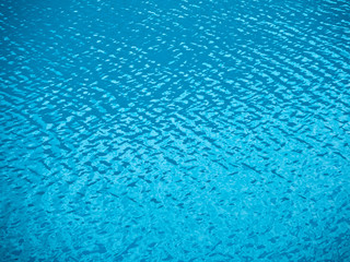Fototapeta na wymiar Rippled water texture. Natural background of blue sea or lake surface