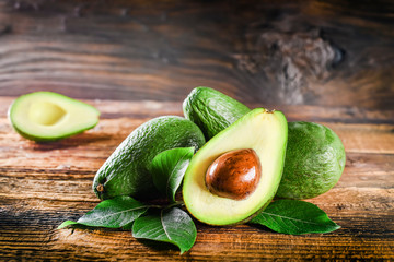 Avocado on rustic wooden table.