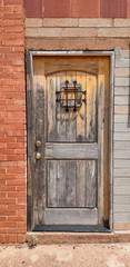 Fototapeta na wymiar old wooden door in a brick wall