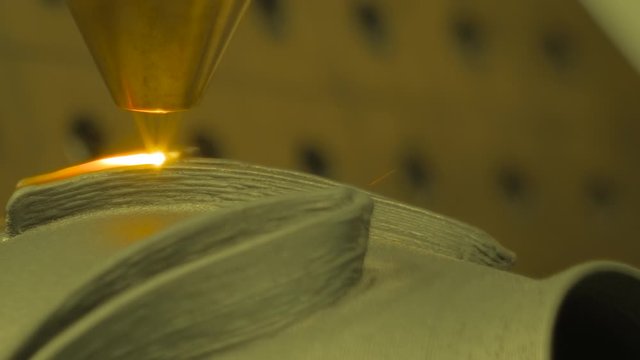 Metalworking, robotic, industrial concept. Direct metal deposition - advanced additive laser melting, powder spray manufacturing technology for repair, rebuild metal workpieces - slow motion, close up