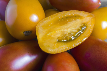 orange and red oval tomatoes close up tomato in section