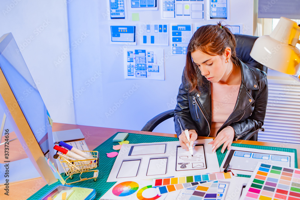 Poster ui/ux designer's office. the girl analyzes different options for the design of the program. intuitiv