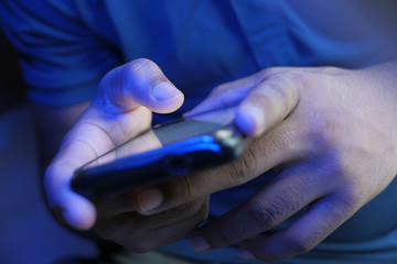 Obraz na płótnie Canvas Close up of young man hand using smart phone.