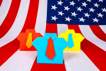 Fototapeta na wymiar The concept of us Presidential elections. Candidates for the post of American President. Origami political men on the background of the flag of the USA.Voting for a candidate For the post of President