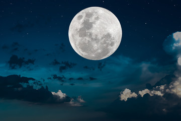 Naklejka na ściany i meble Full moon over clouds on the sky.