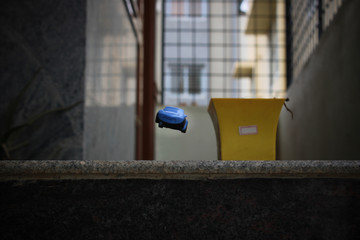 Selective focus on a toy car falling off a plight of stairs.