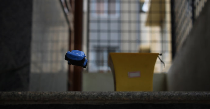 Selective focus on a toy car falling off a plight of stairs.