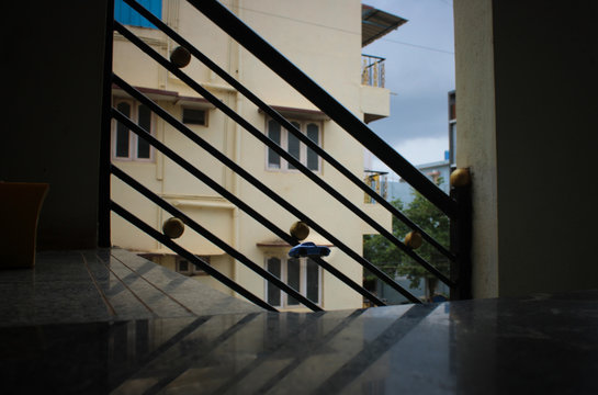 Selective focus on a toy car falling off a plight of stairs.