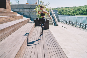 Strong female stretching legs at waterfront