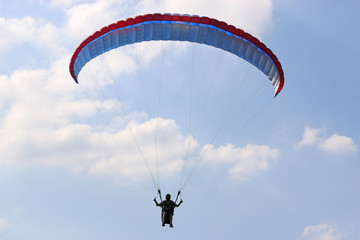 Paraglider flying wing in a blue sky	
