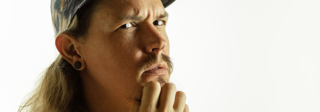 Thoughtful. Caucasian young man's close up shot on studio background, flyer. Concept of human emotions, facial expression, sales, ad. Copyspace. Beautiful male model with bright expressive emotion.