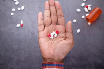 Close up of man hand taking medicine 