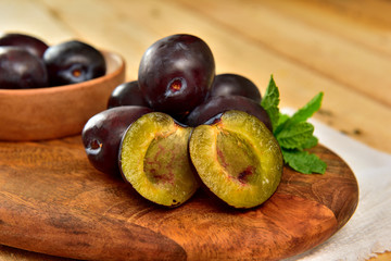 Natural organic blue Plums in a wooden board