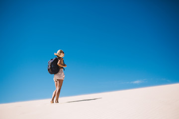 Woman walking on sand in desert