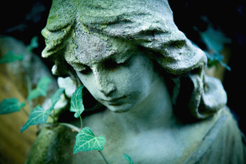 Beautiful sad angel. Ancient statue. Religion, faith, death, resurrection, eternity concept.