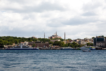 Fototapeta na wymiar Panoramic shot of the old town Istanbul; The Hagia Sophia (Ayasofya) Mosque Eminonu, ferries and boats on the Golden Horn, Istanbul, Turkey.