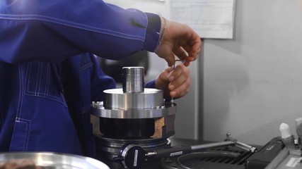 Man worker is screwing and fixing a mechanism