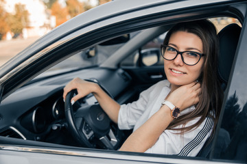 Beautiful young happy smiling woman driving her car.